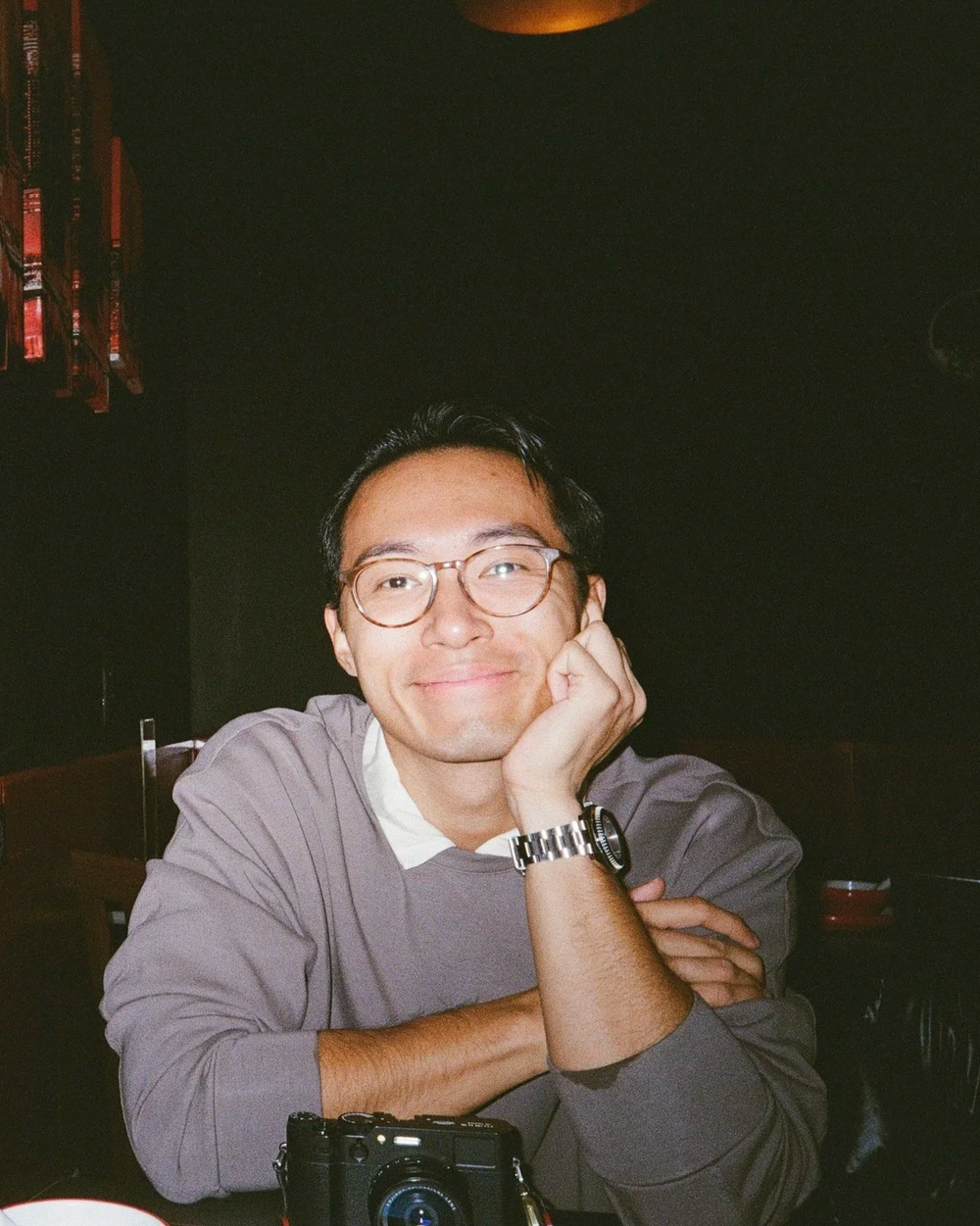 Zian Meng seated at a table with a camera